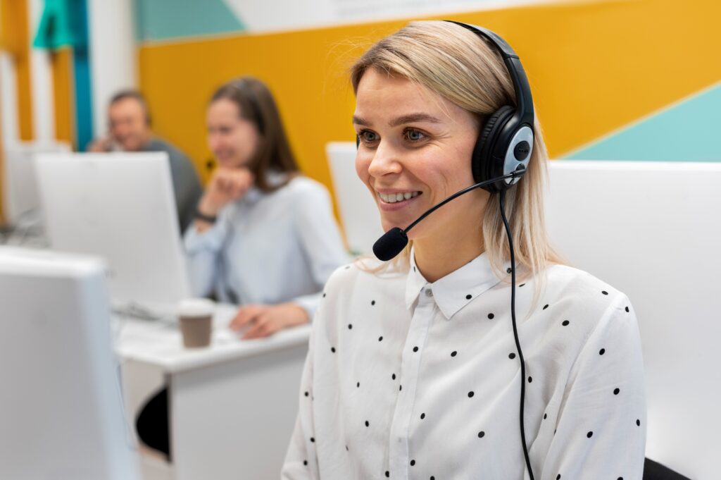 blond-woman-working-call-center-with-headphones-computer