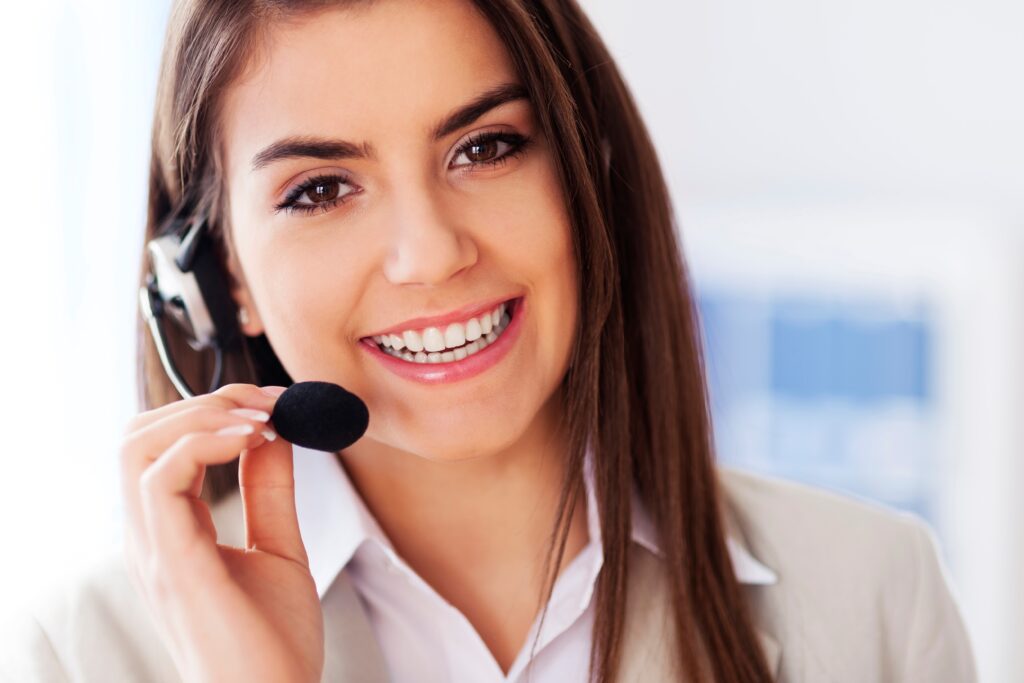 Happy female wearing headset and looking at camera