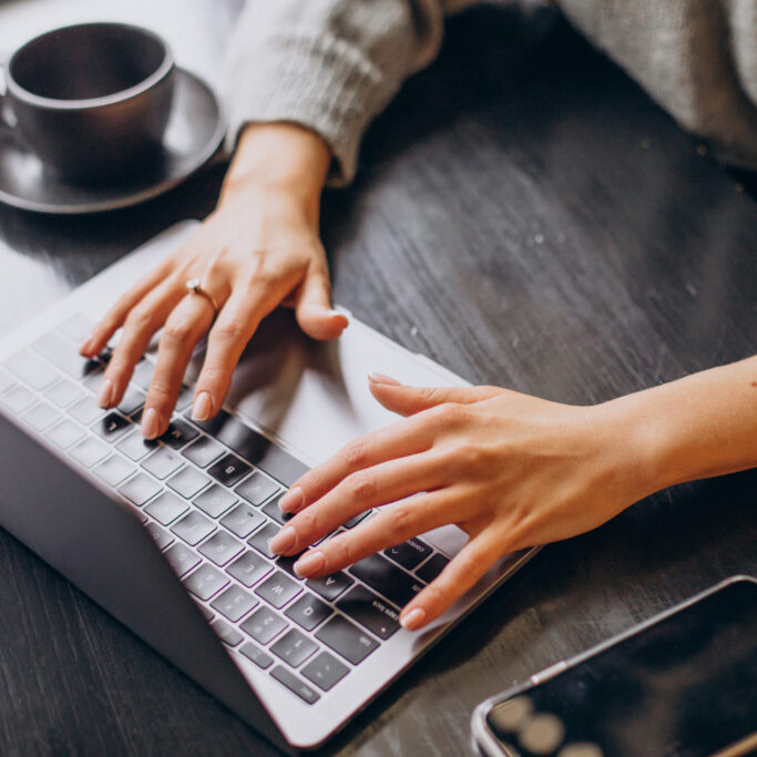 Female hands typing on computer keyboard